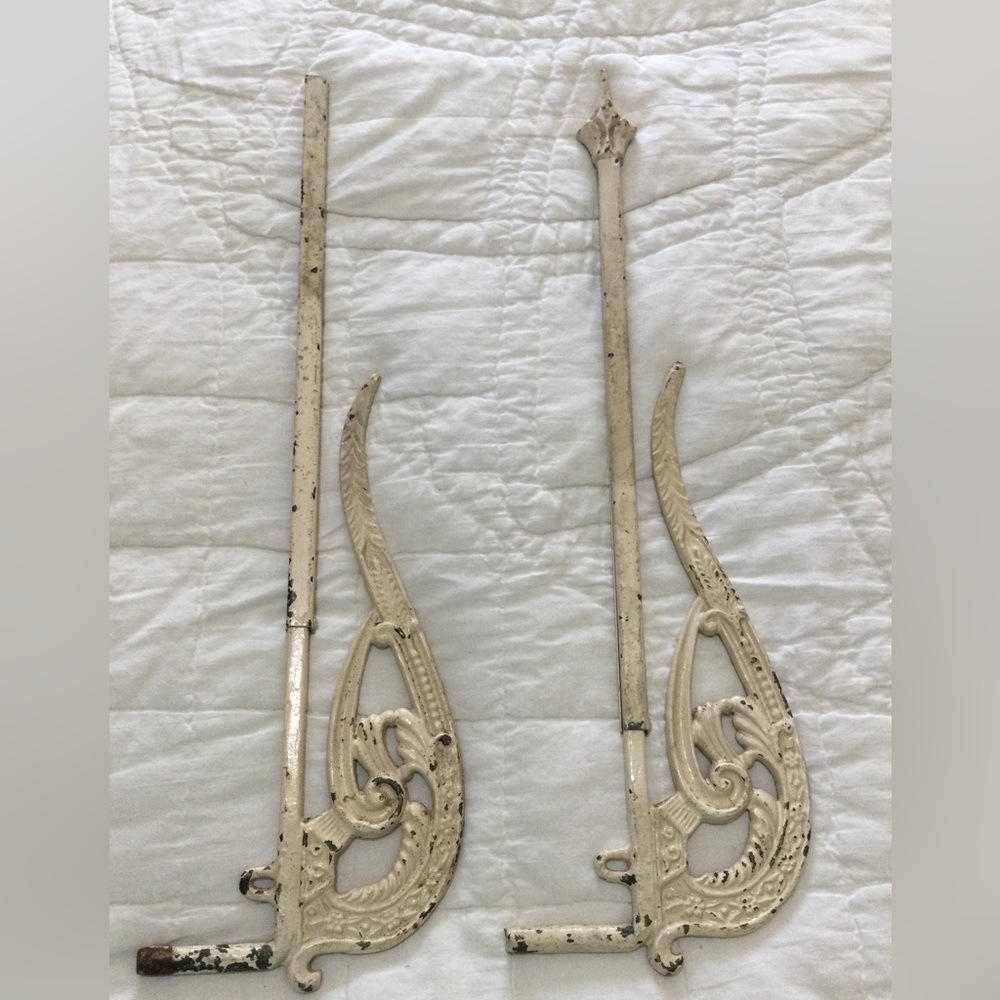 Two antique cream color metal swing arm curtain/drapery rods